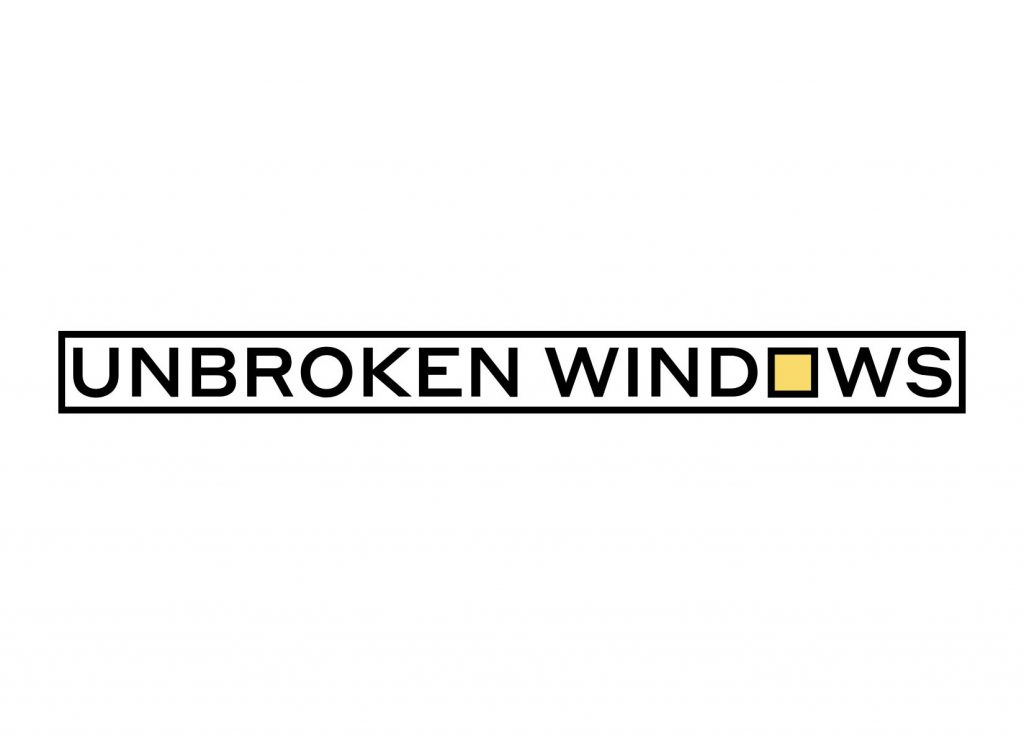 Held tight by a black frame, austere capital letters of a similar thickness to the frame itself spell out “Unbroken Windows” on a white background. The “o” in “Windows” is square, and filled with a glowing yellow light.